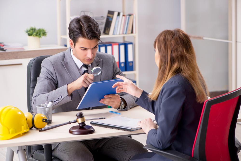 A lawyer and client discussing a workers’ compensation claim.